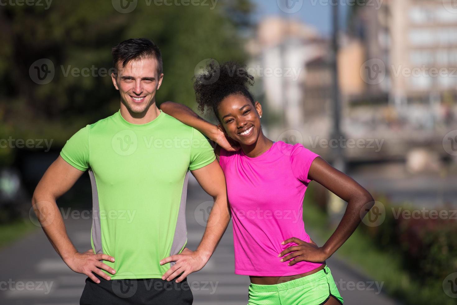 portrait of young multietnic jogging couple ready to run photo