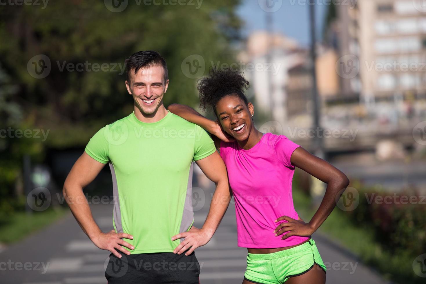 portrait of young multietnic jogging couple ready to run photo