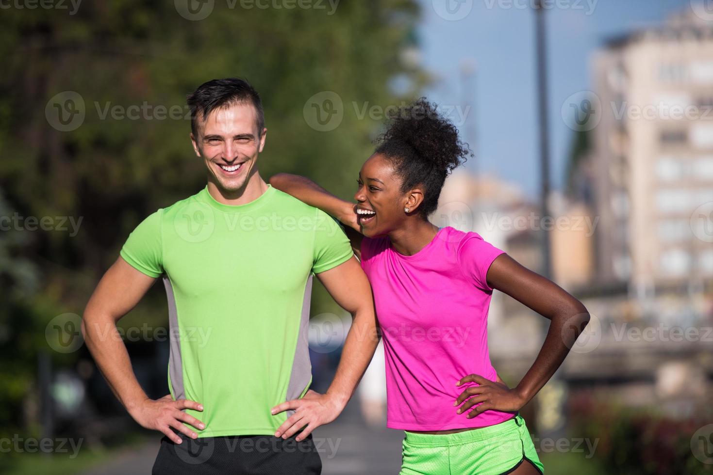 portrait of young multietnic jogging couple ready to run photo
