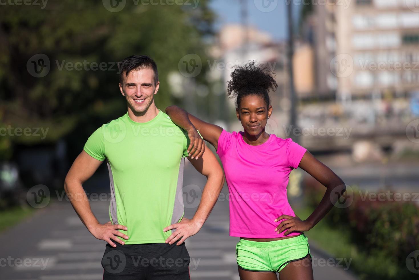 portrait of young multietnic jogging couple ready to run photo