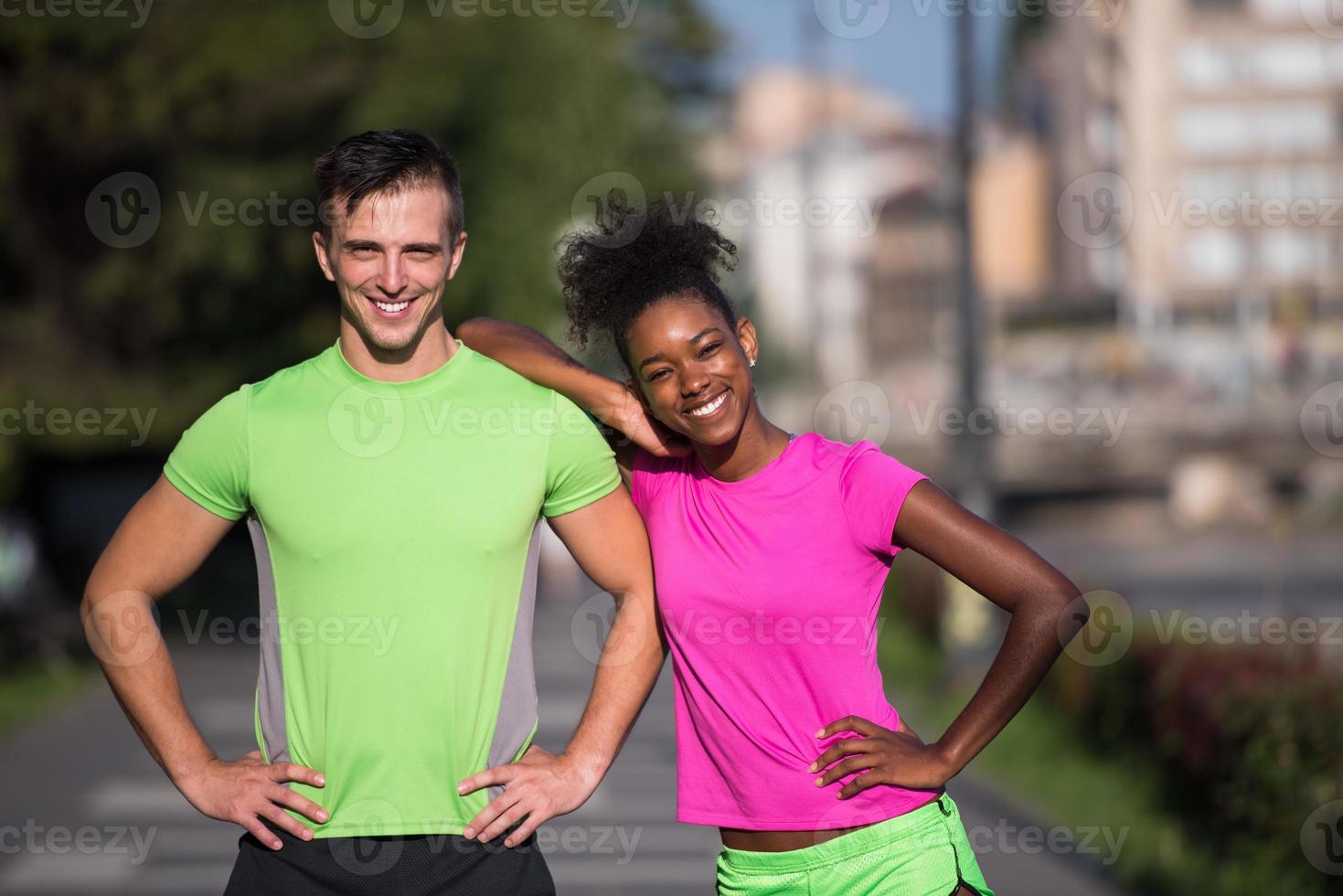 portrait of young multietnic jogging couple ready to run photo