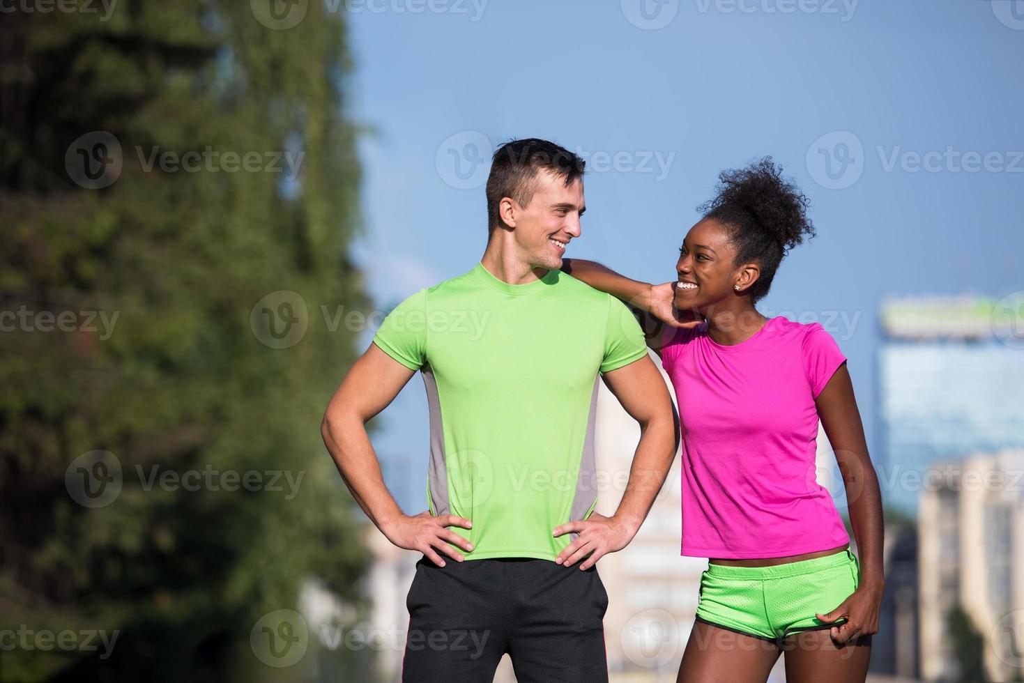 portrait of young multietnic jogging couple ready to run photo