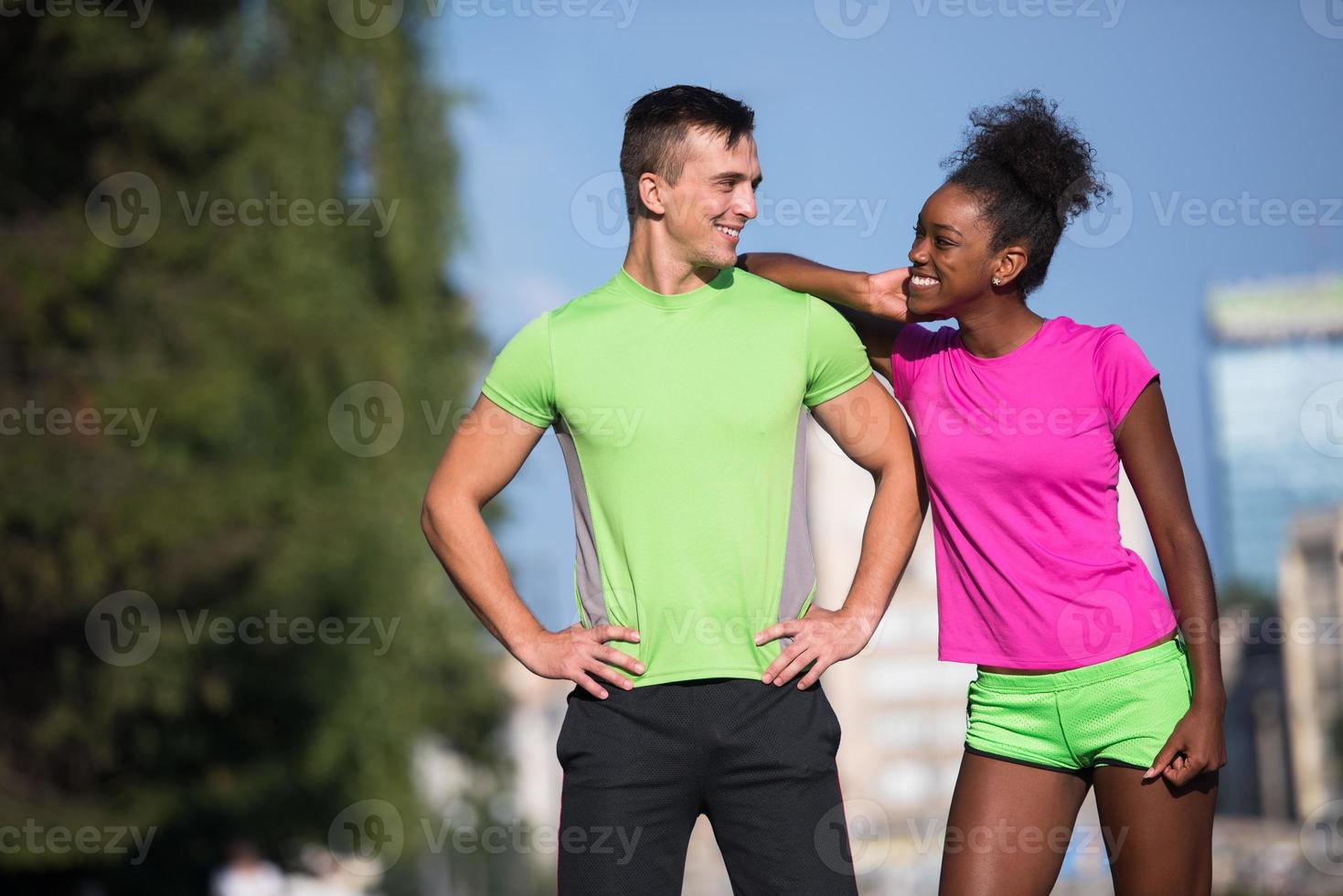 portrait of young multietnic jogging couple ready to run photo