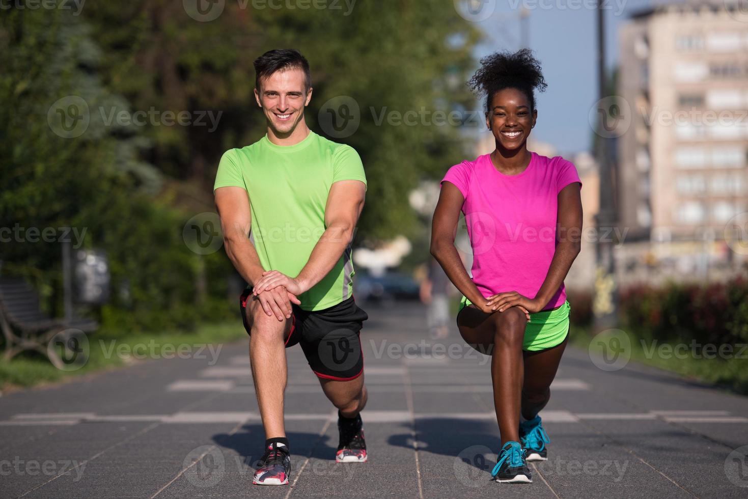 jogging couple warming up and stretching in the city photo