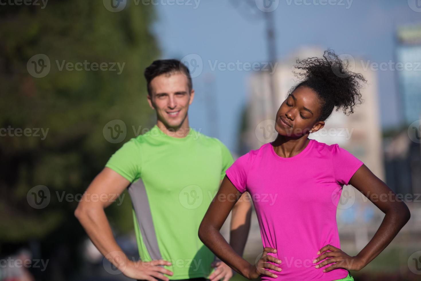 portrait of young multietnic jogging couple ready to run photo