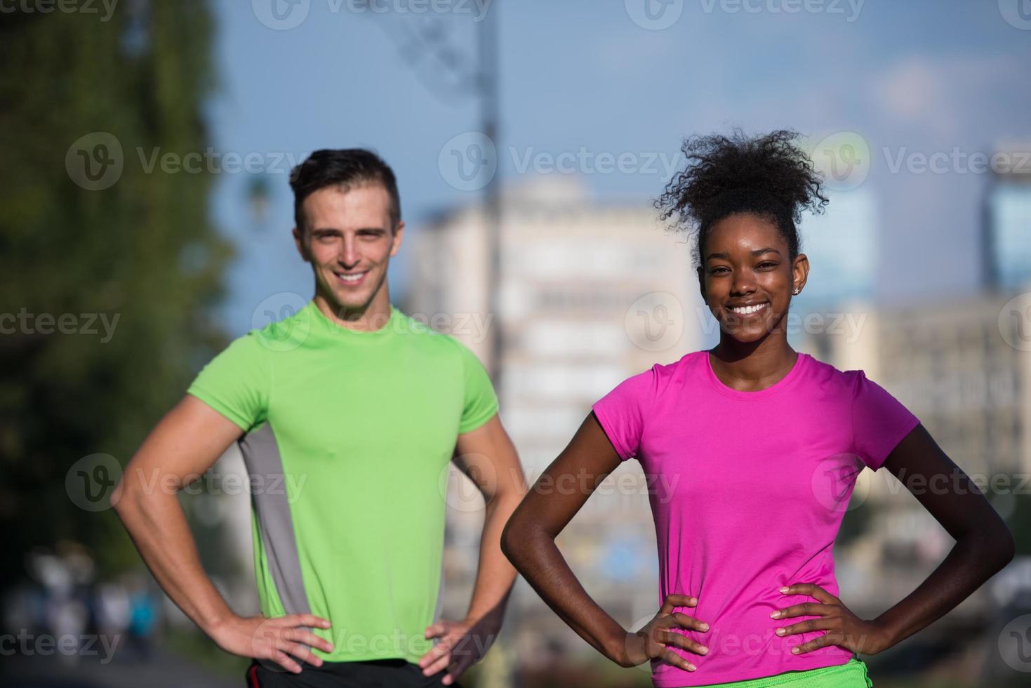 portrait of young multietnic jogging couple ready to run photo