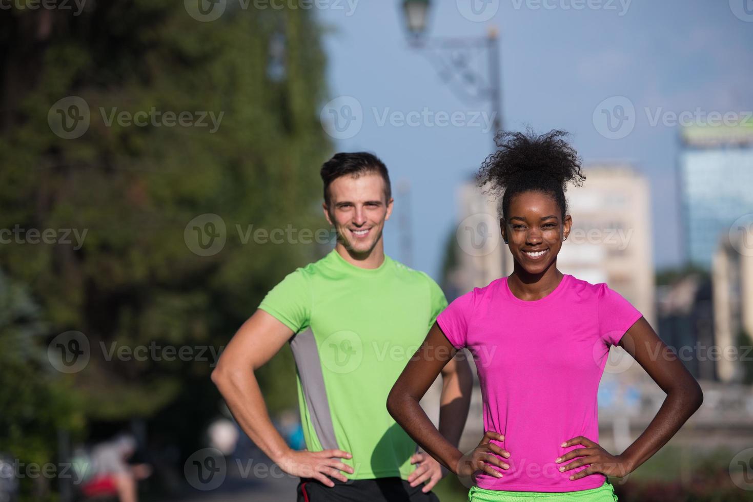 portrait of young multietnic jogging couple ready to run photo