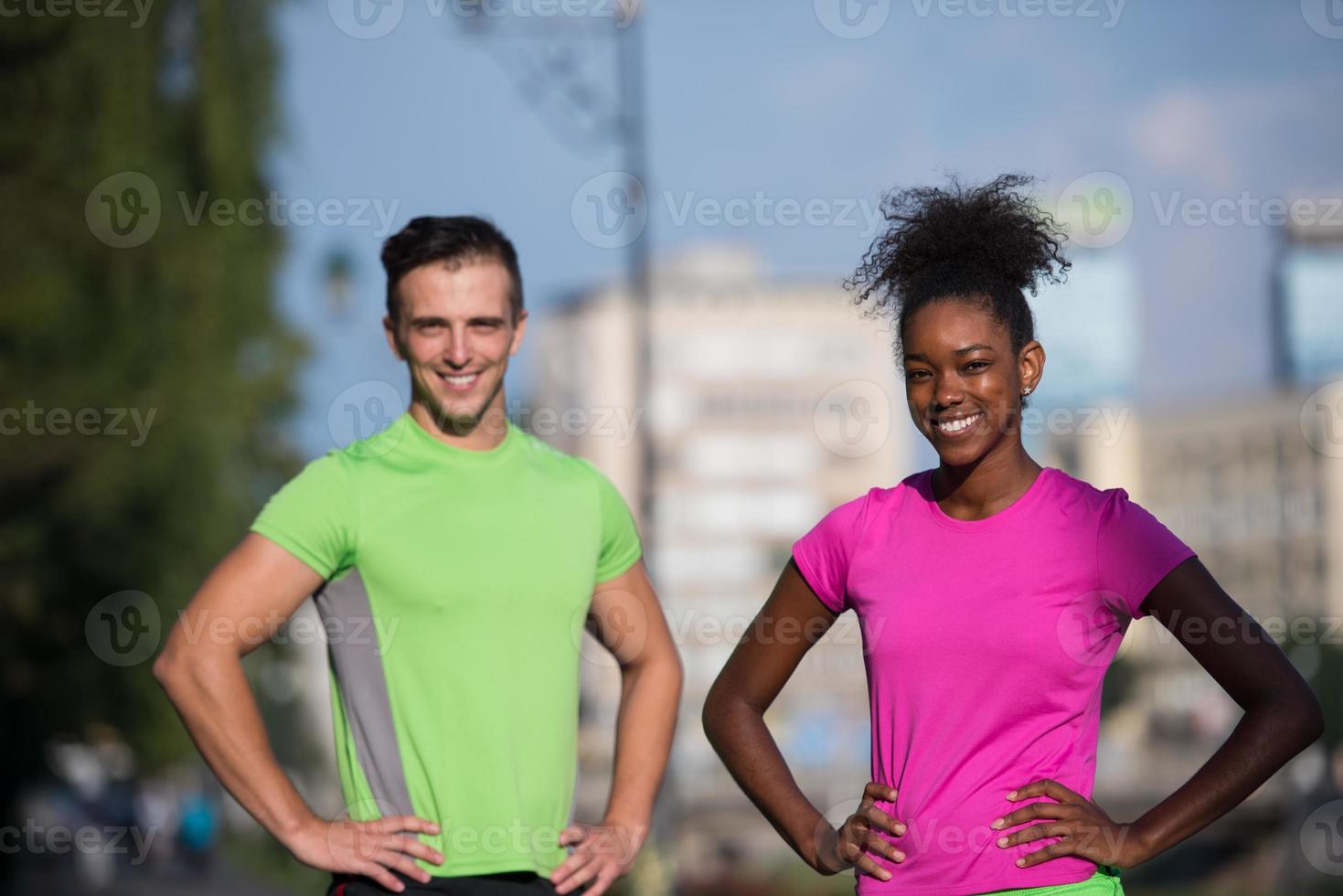 portrait of young multietnic jogging couple ready to run photo