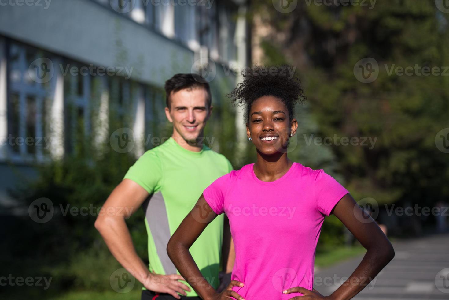portrait of young multietnic jogging couple ready to run photo