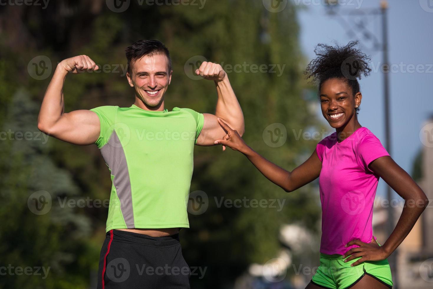 portrait of young multietnic jogging couple ready to run photo