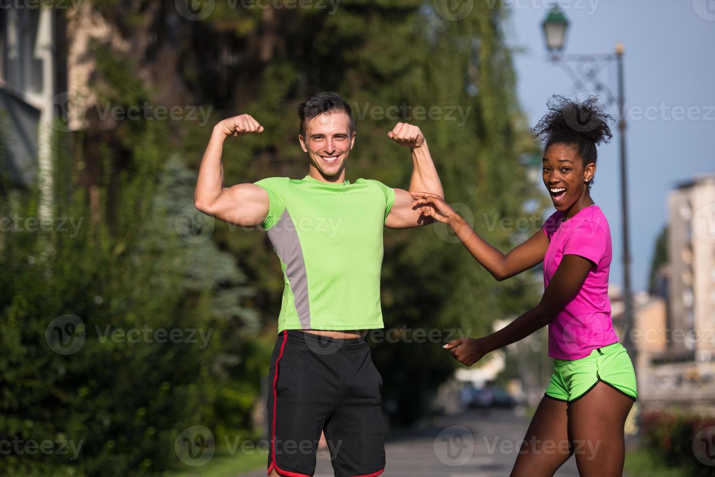 portrait of young multietnic jogging couple ready to run photo