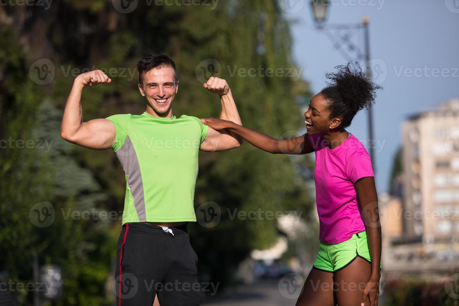 portrait of young multietnic jogging couple ready to run photo