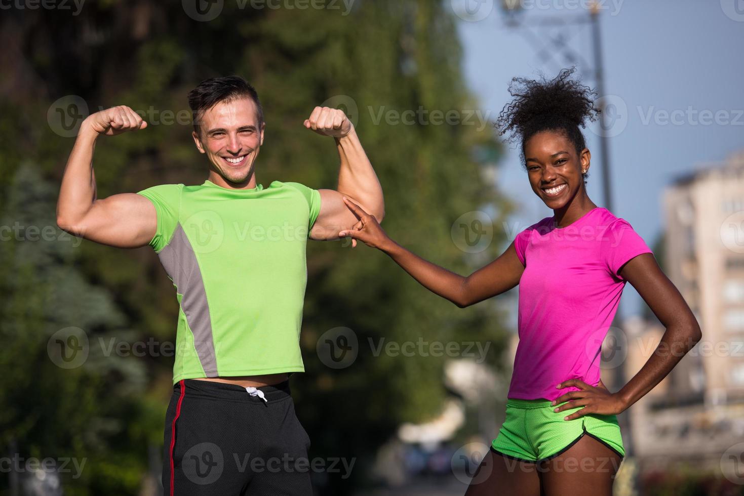 portrait of young multietnic jogging couple ready to run photo