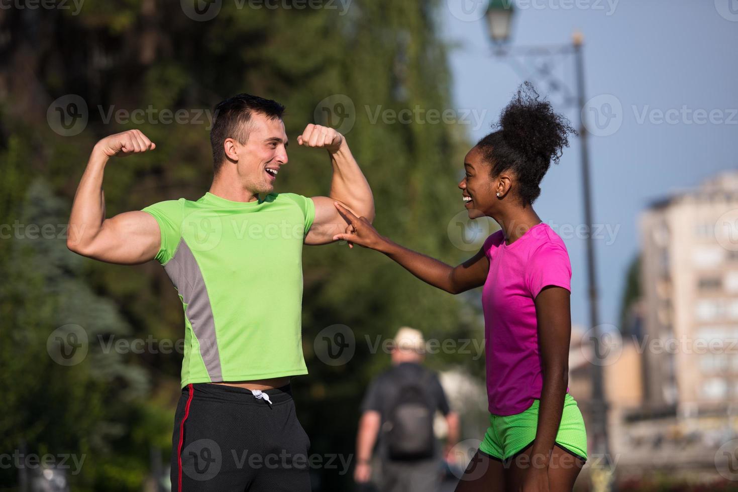 portrait of young multietnic jogging couple ready to run photo