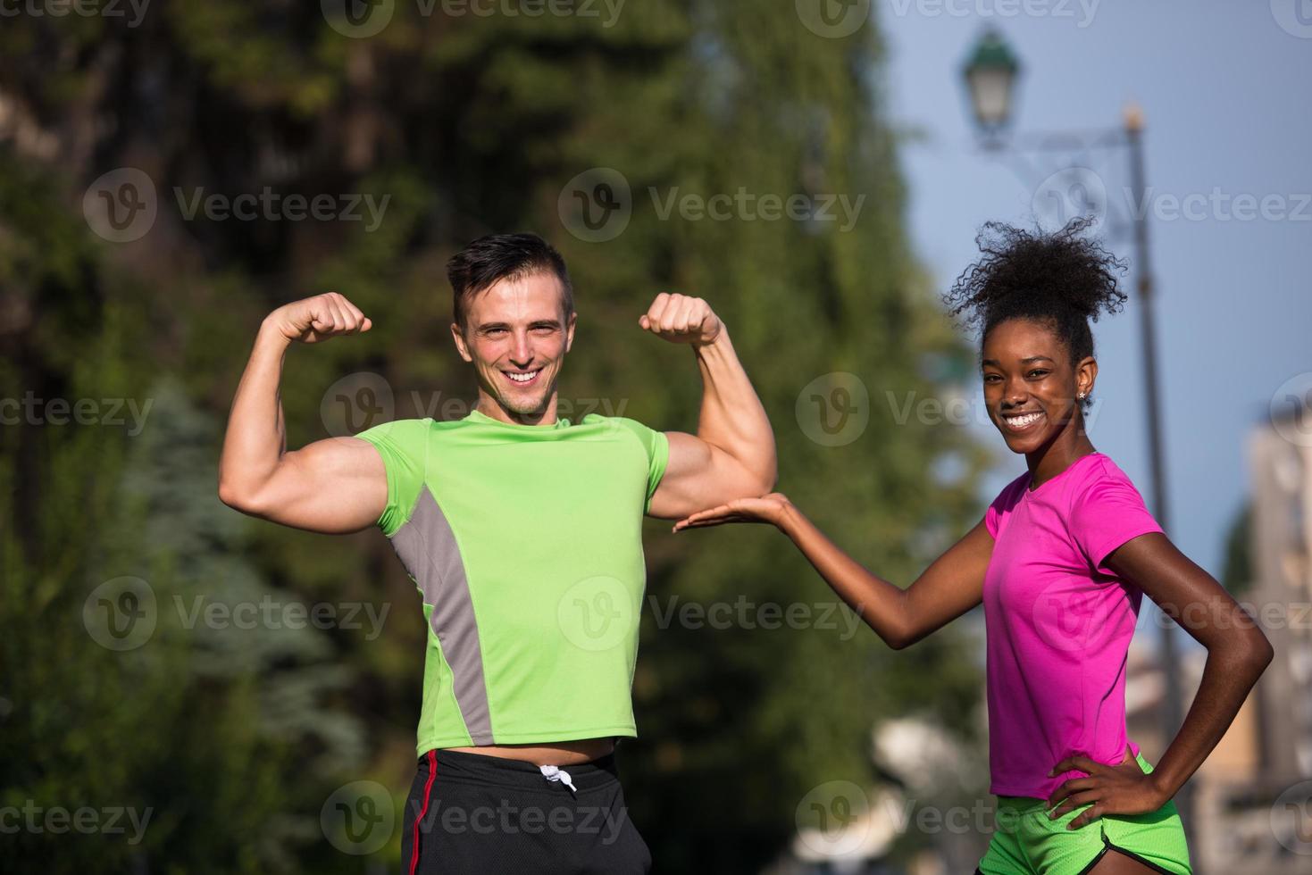 portrait of young multietnic jogging couple ready to run photo