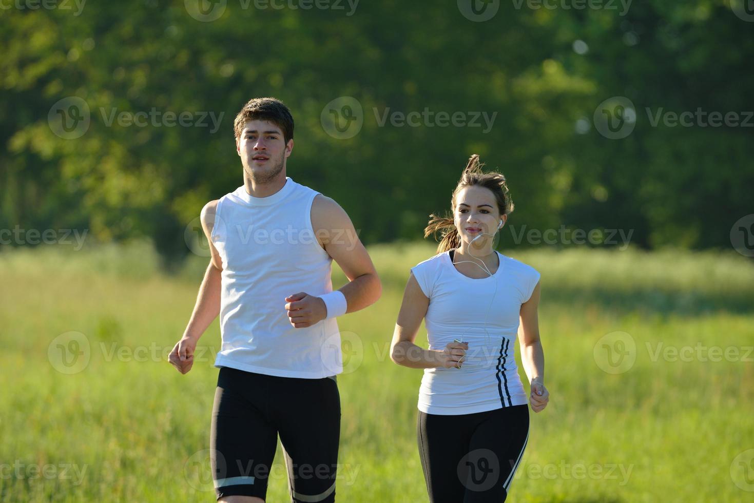 Young couple jogging at morning photo