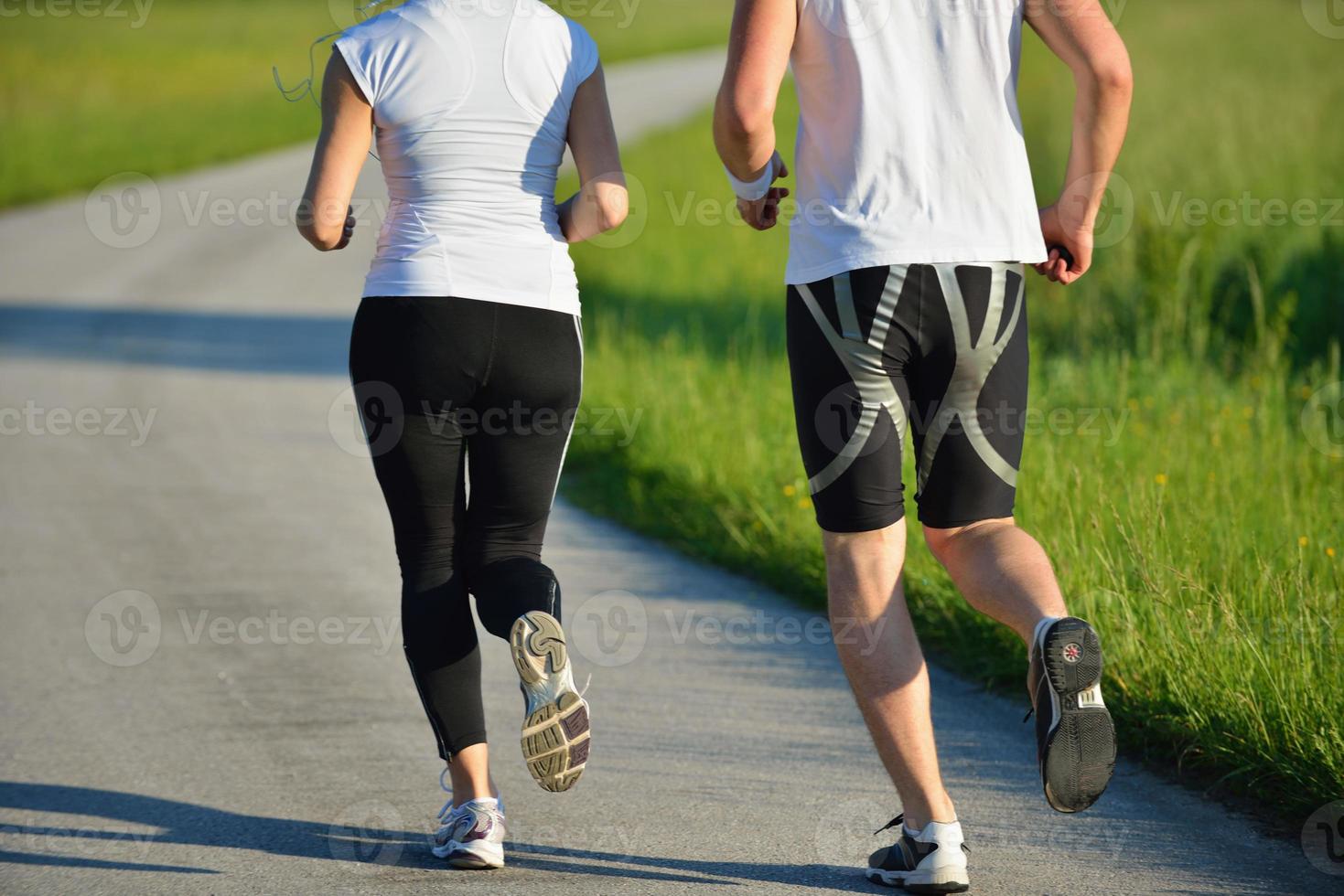 Young couple jogging at morning photo
