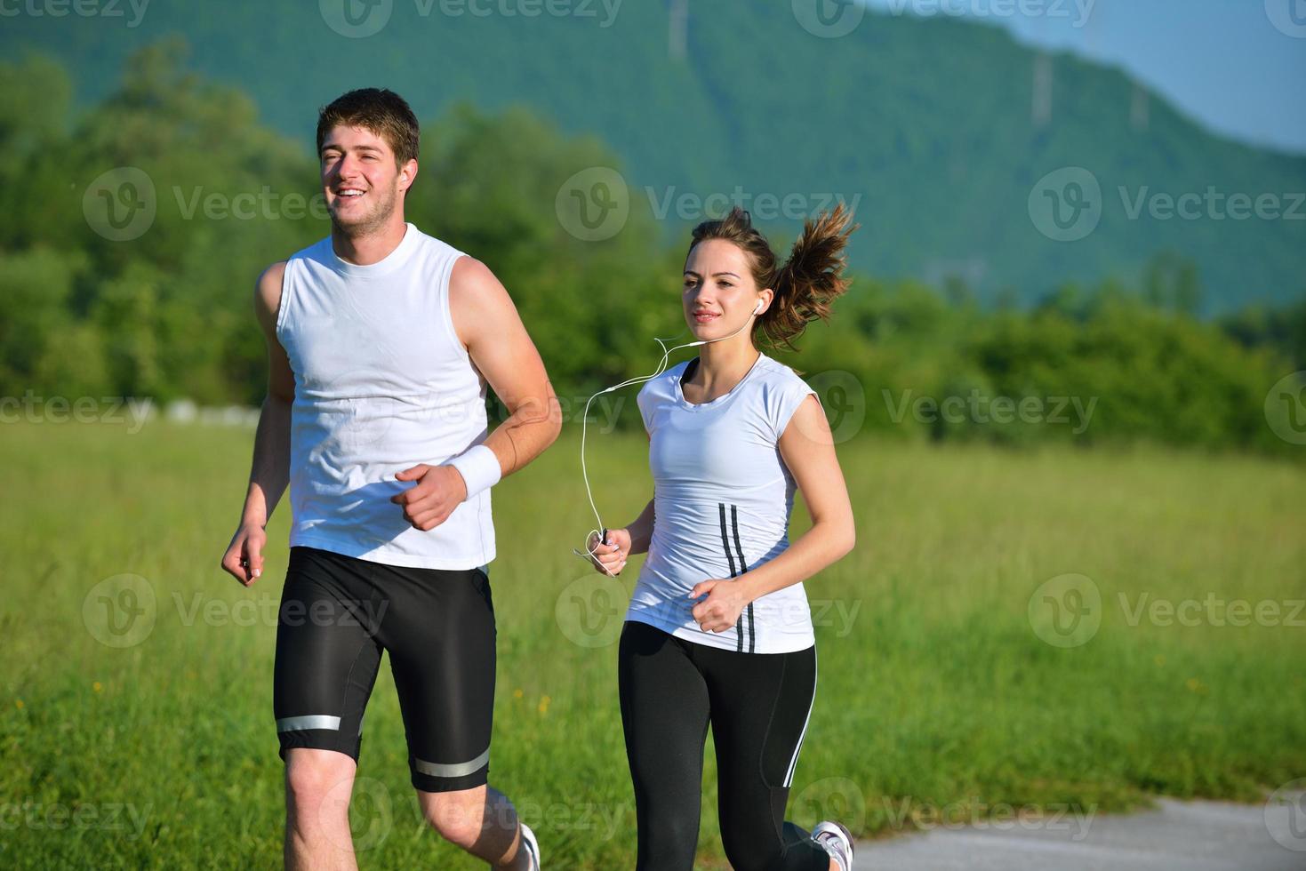 Young couple jogging at morning photo