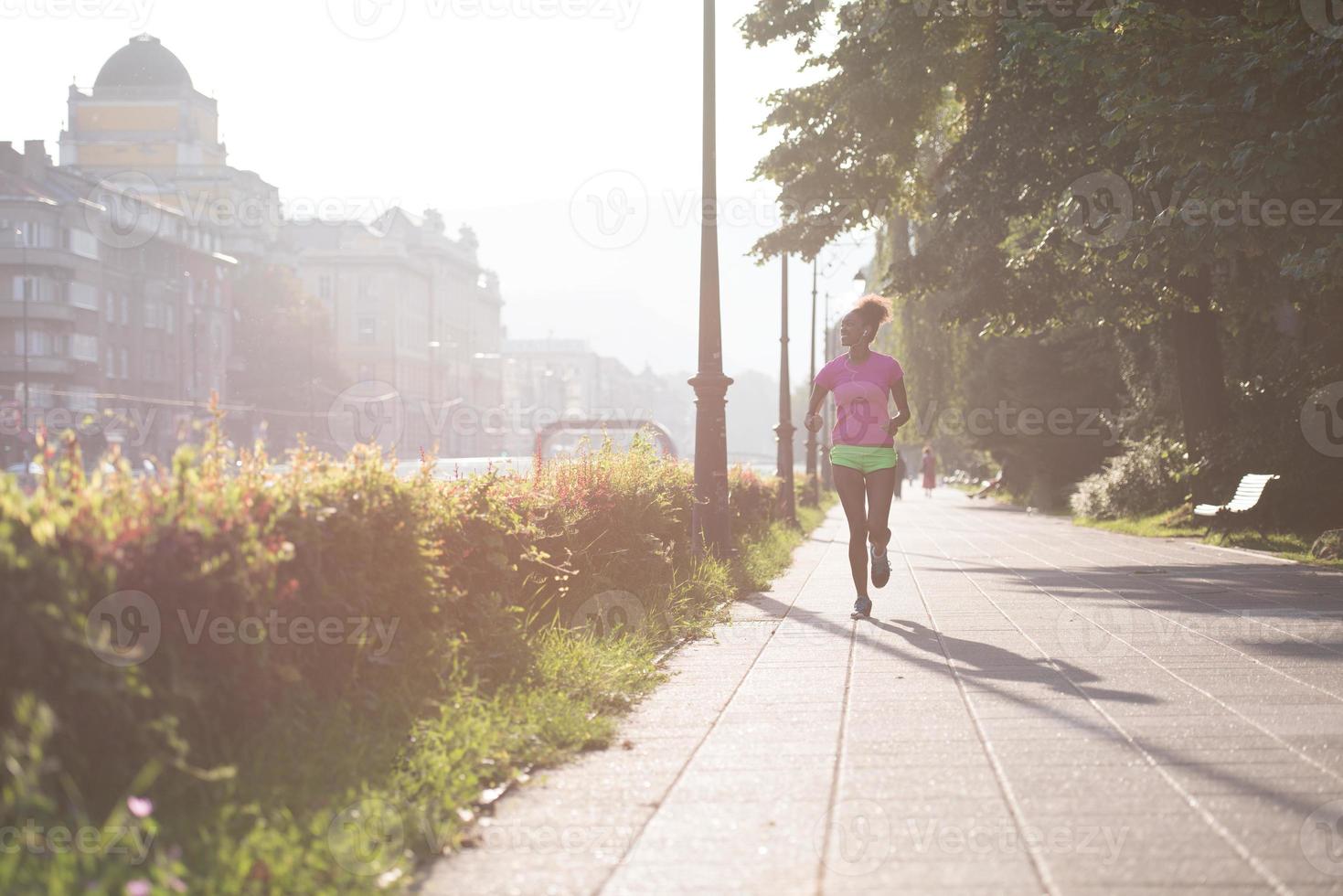 african american woman jogging in the city photo