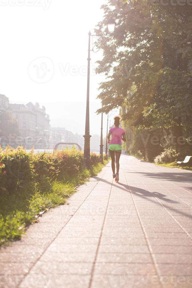 african american woman jogging in the city photo