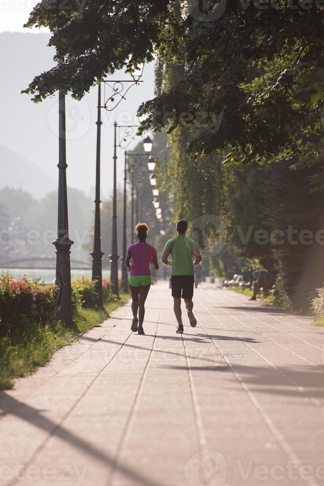 young multiethnic couple jogging in the city photo