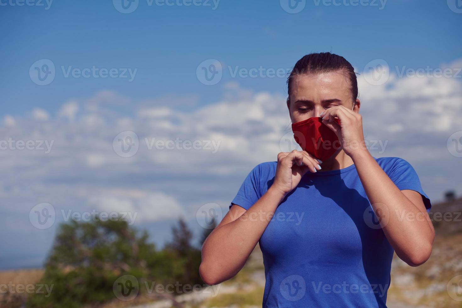 woman with protective mask  relaxing after running photo