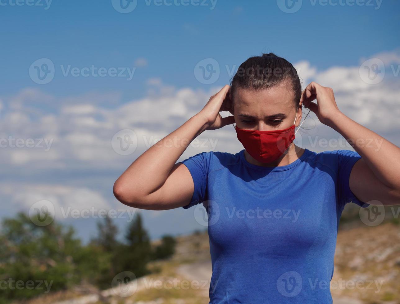 woman with protective mask  relaxing after running photo