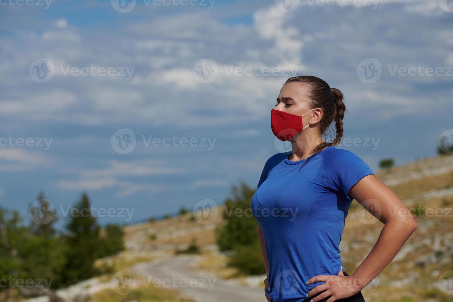 woman with protective mask  relaxing after running photo
