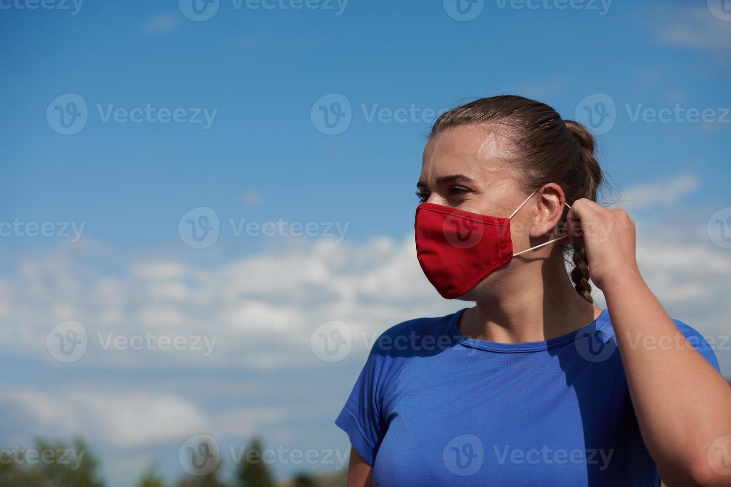 woman with protective mask  relaxing after running photo
