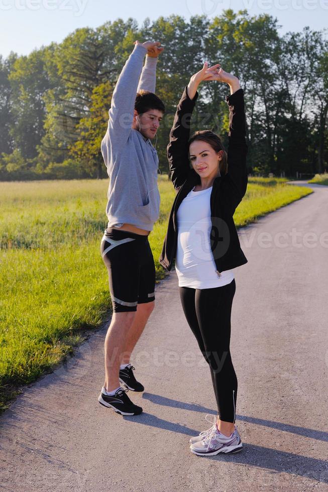 Couple doing stretching exercise  after jogging photo