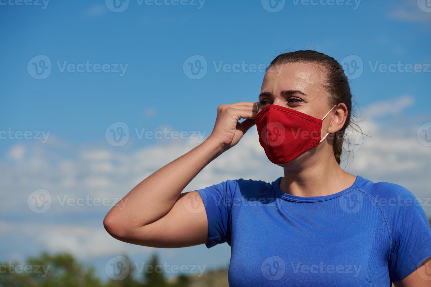 woman with protective mask  relaxing after running photo
