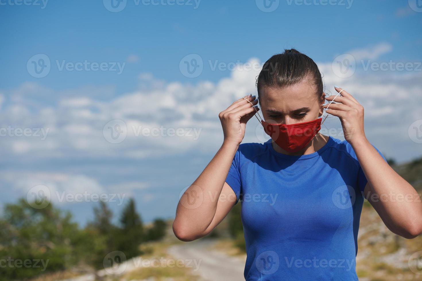 woman with protective mask  relaxing after running photo