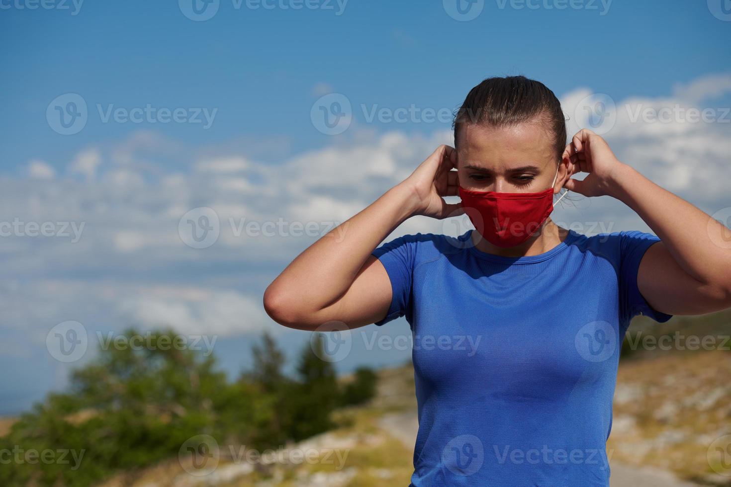 woman with protective mask  relaxing after running photo