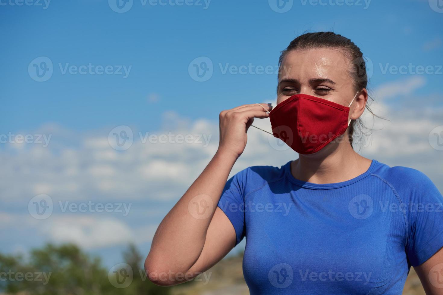 woman with protective mask  relaxing after running photo