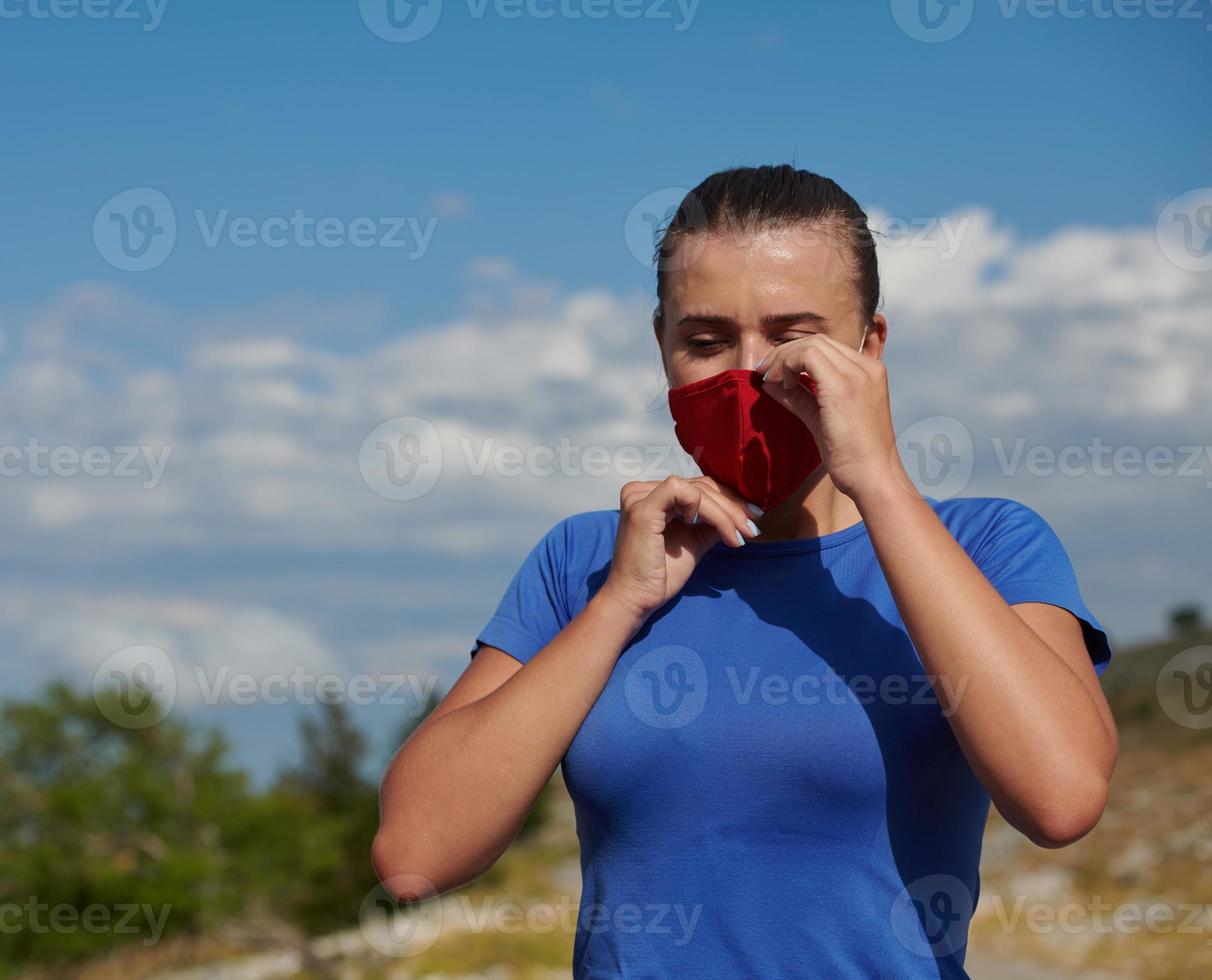 woman with protective mask  relaxing after running photo