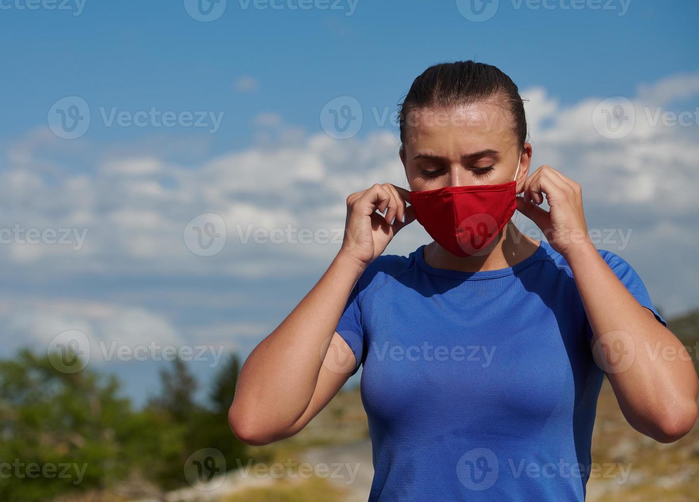 woman with protective mask  relaxing after running photo