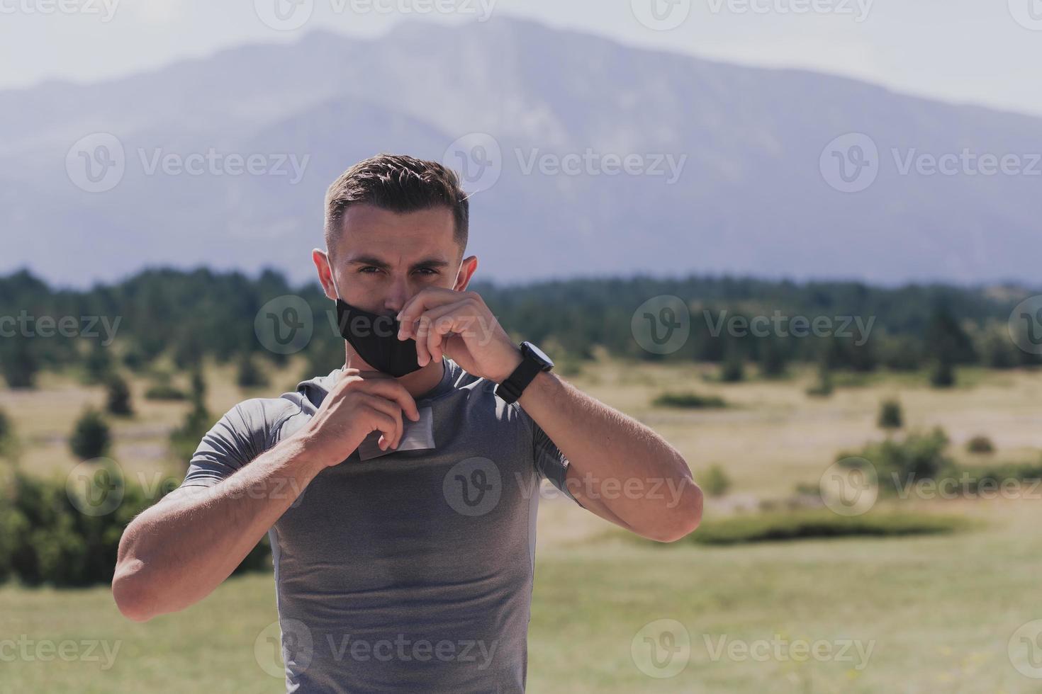 Young man and woman in protective masks running and doing exercises outdoors in the morning. Sport, Active life Jogging during quarantine. Covid-19 new normal. High quality photo. Selective focus. photo