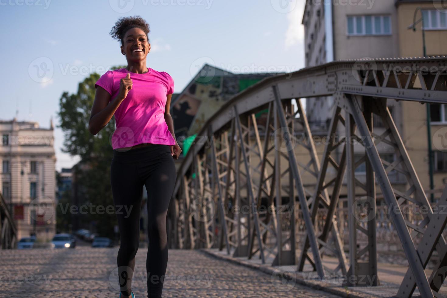 african american woman running across the bridge photo