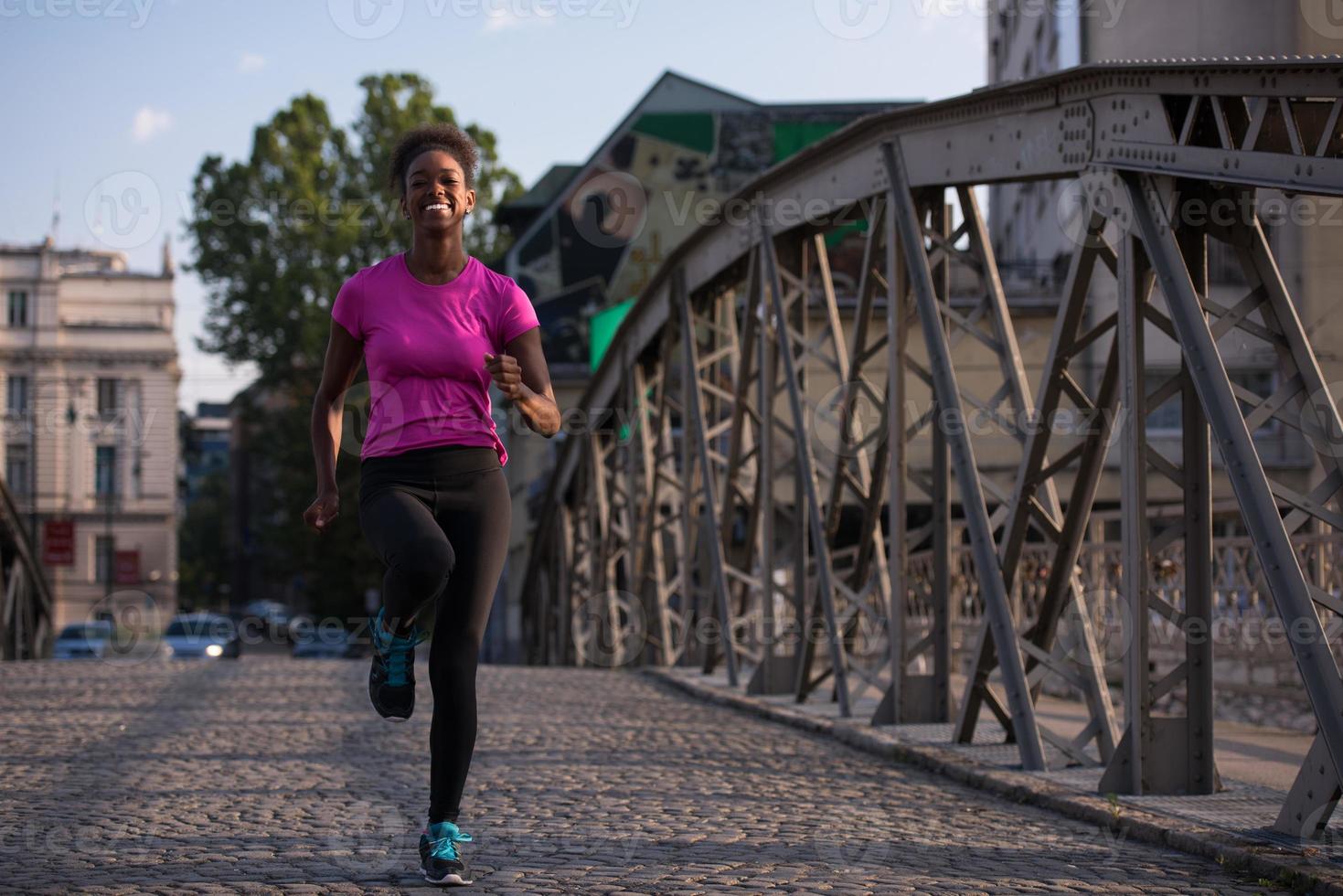 african american woman running across the bridge photo