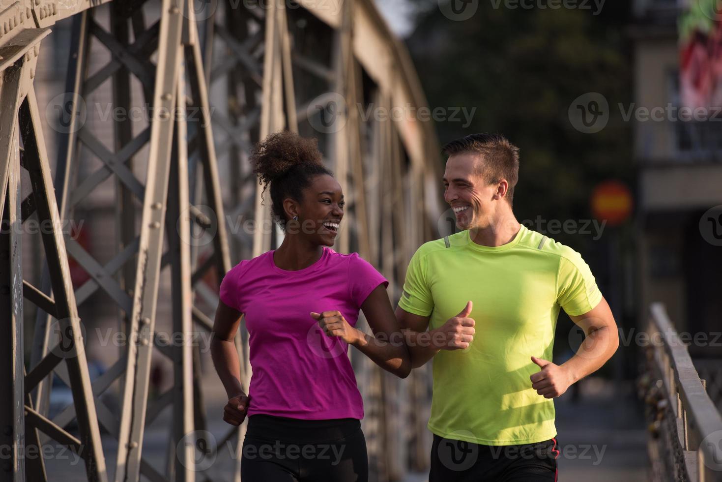 multiethnic couple jogging in the city photo