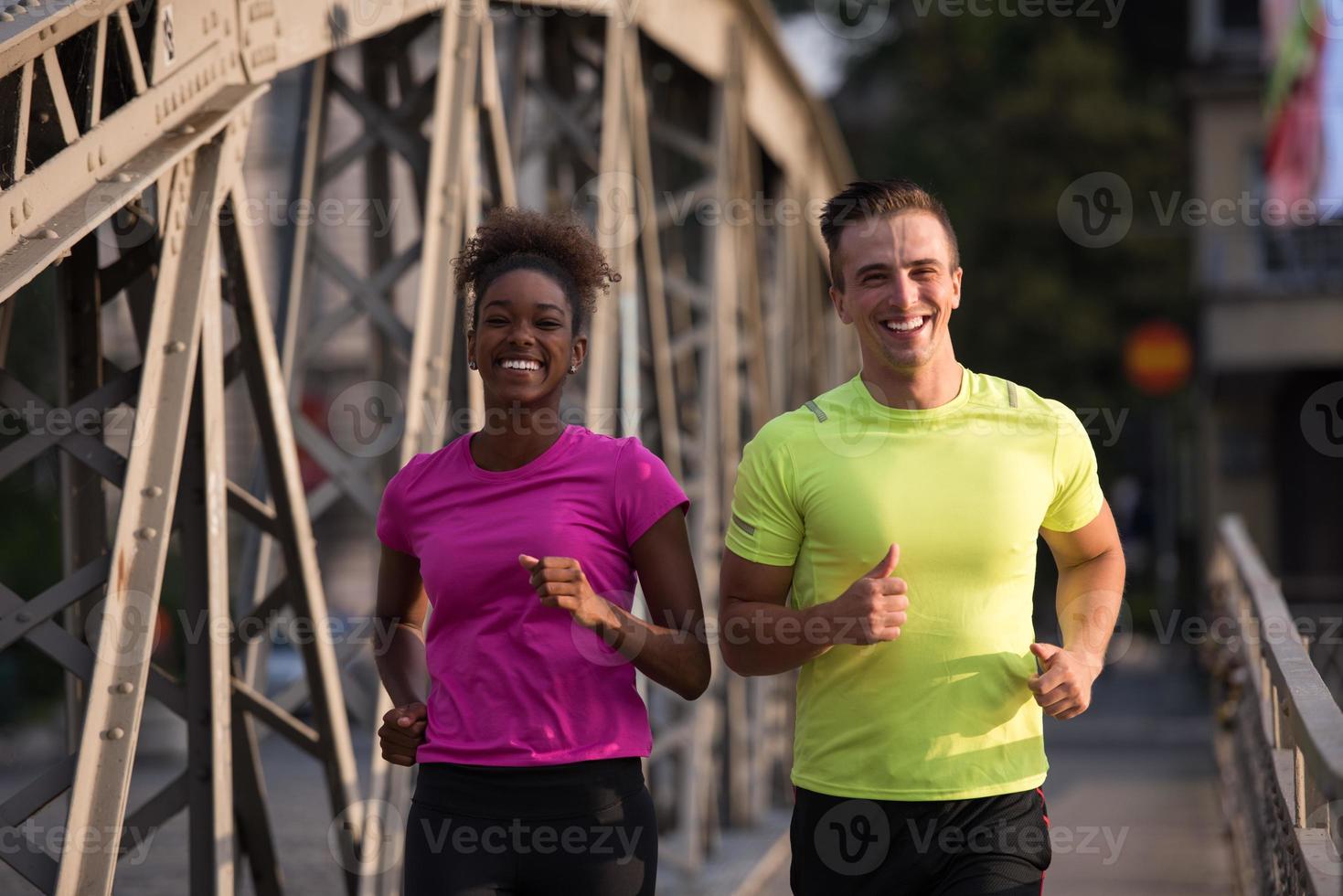 multiethnic couple jogging in the city photo