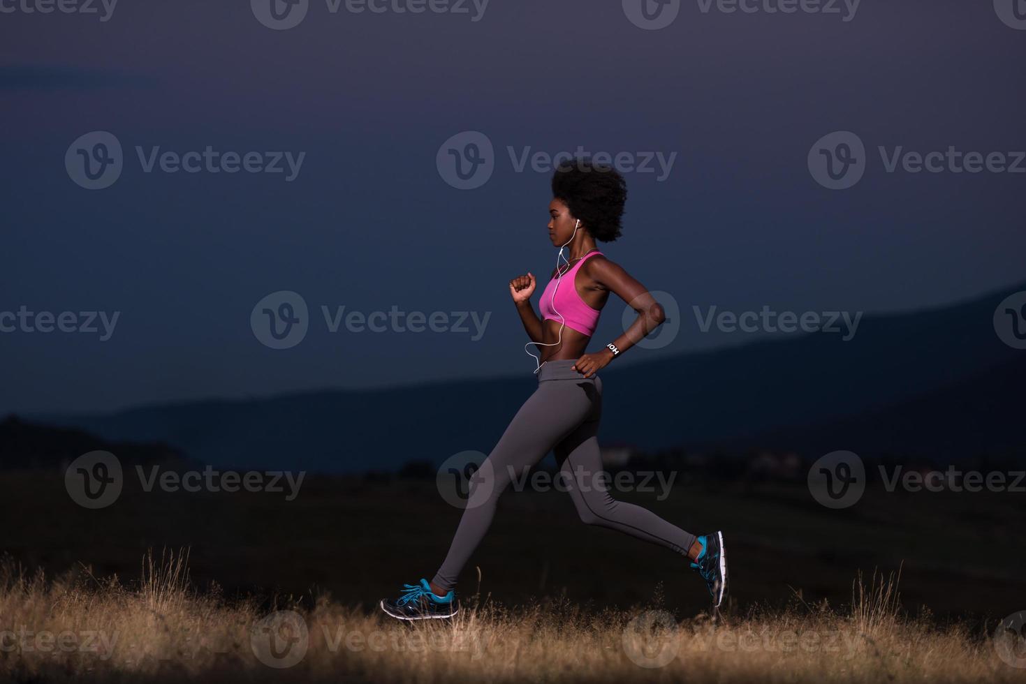 Young African american woman jogging in nature photo