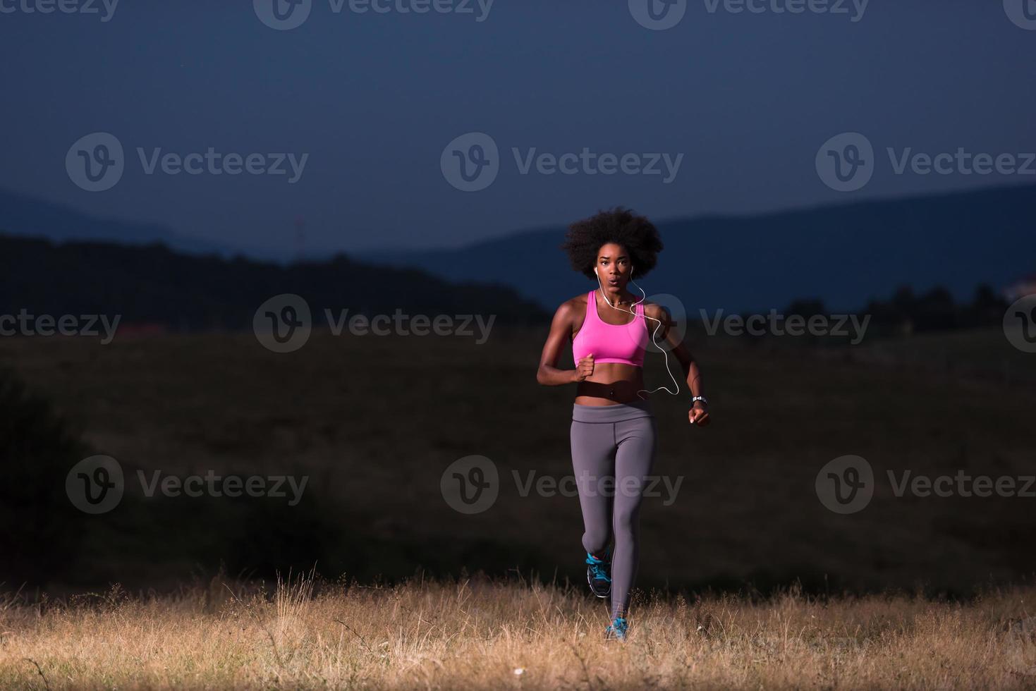 Young African american woman jogging in nature photo