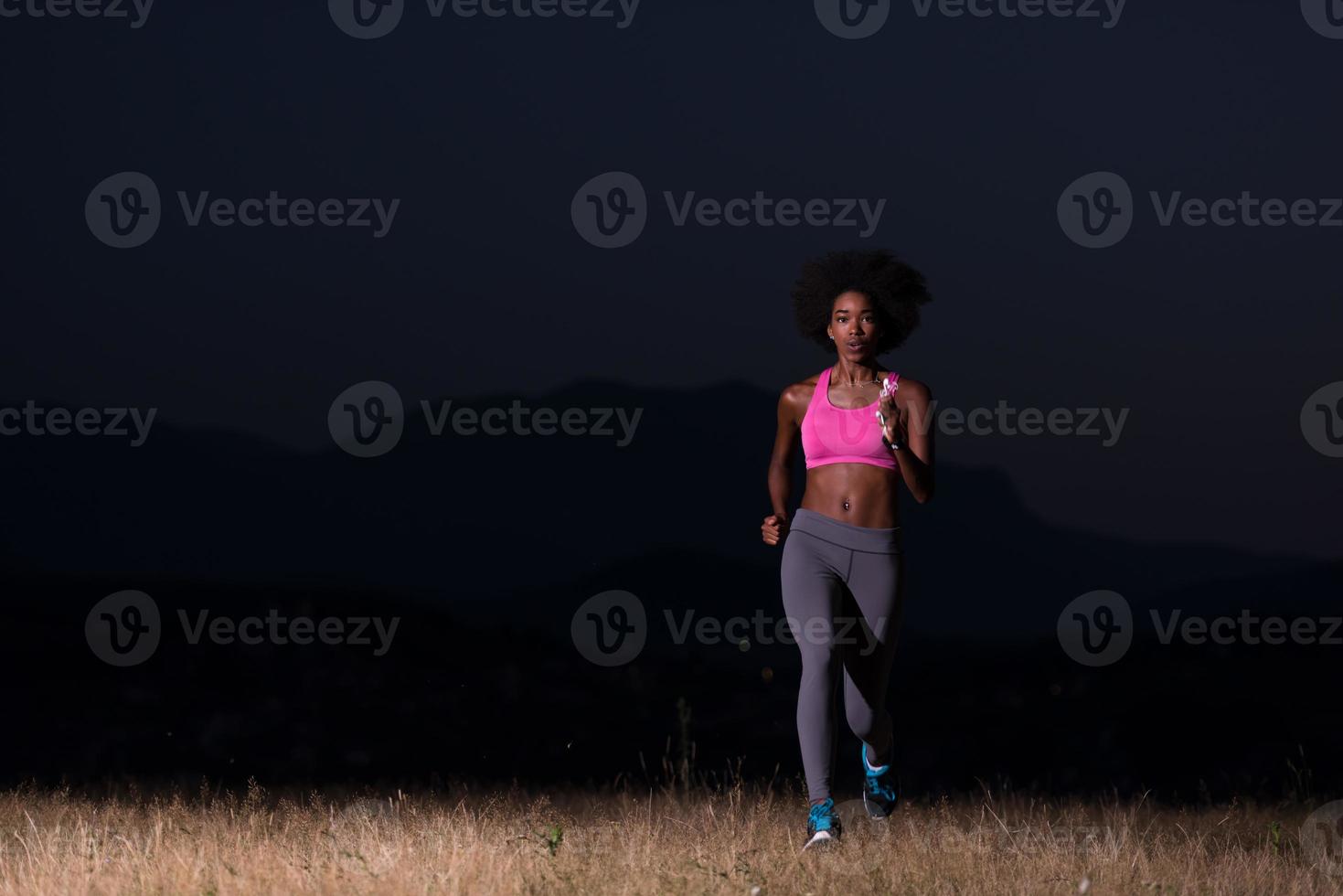 Young African american woman jogging in nature photo