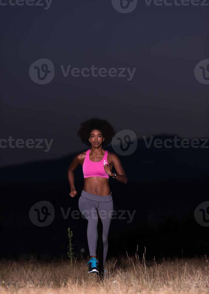 Young African american woman jogging in nature photo