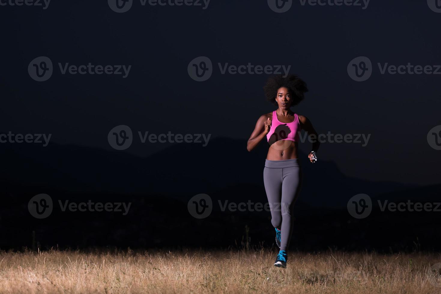 Young African american woman jogging in nature photo