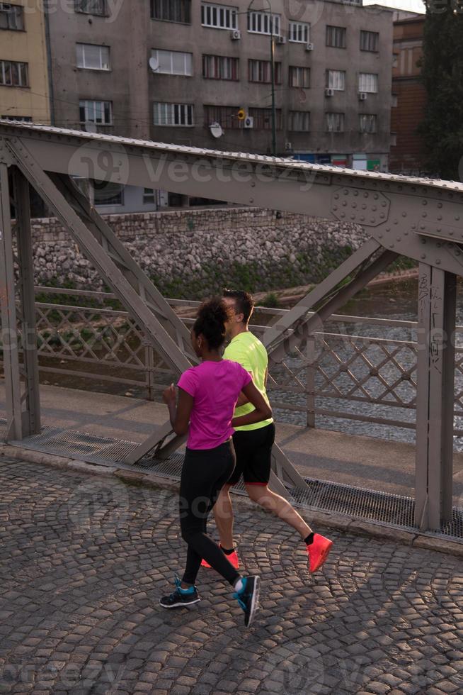 young multiethnic couple jogging in the city photo