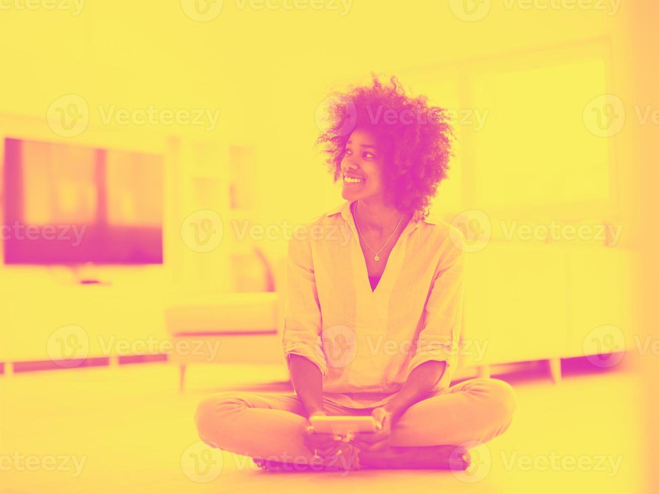 black women using tablet computer on the floor at home photo