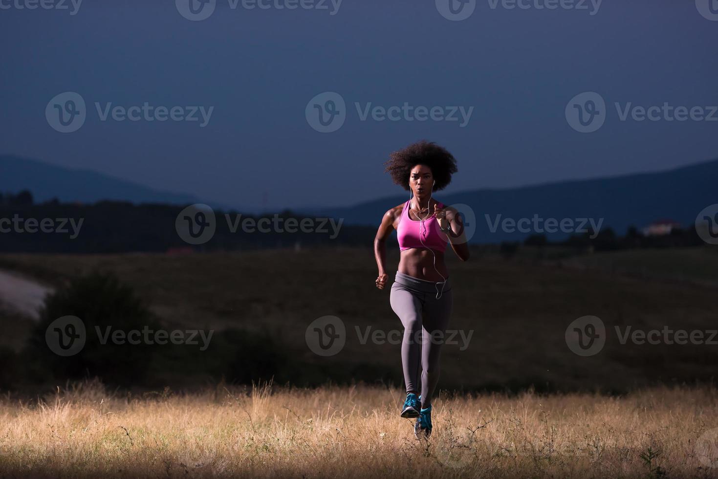 Young African american woman jogging in nature photo