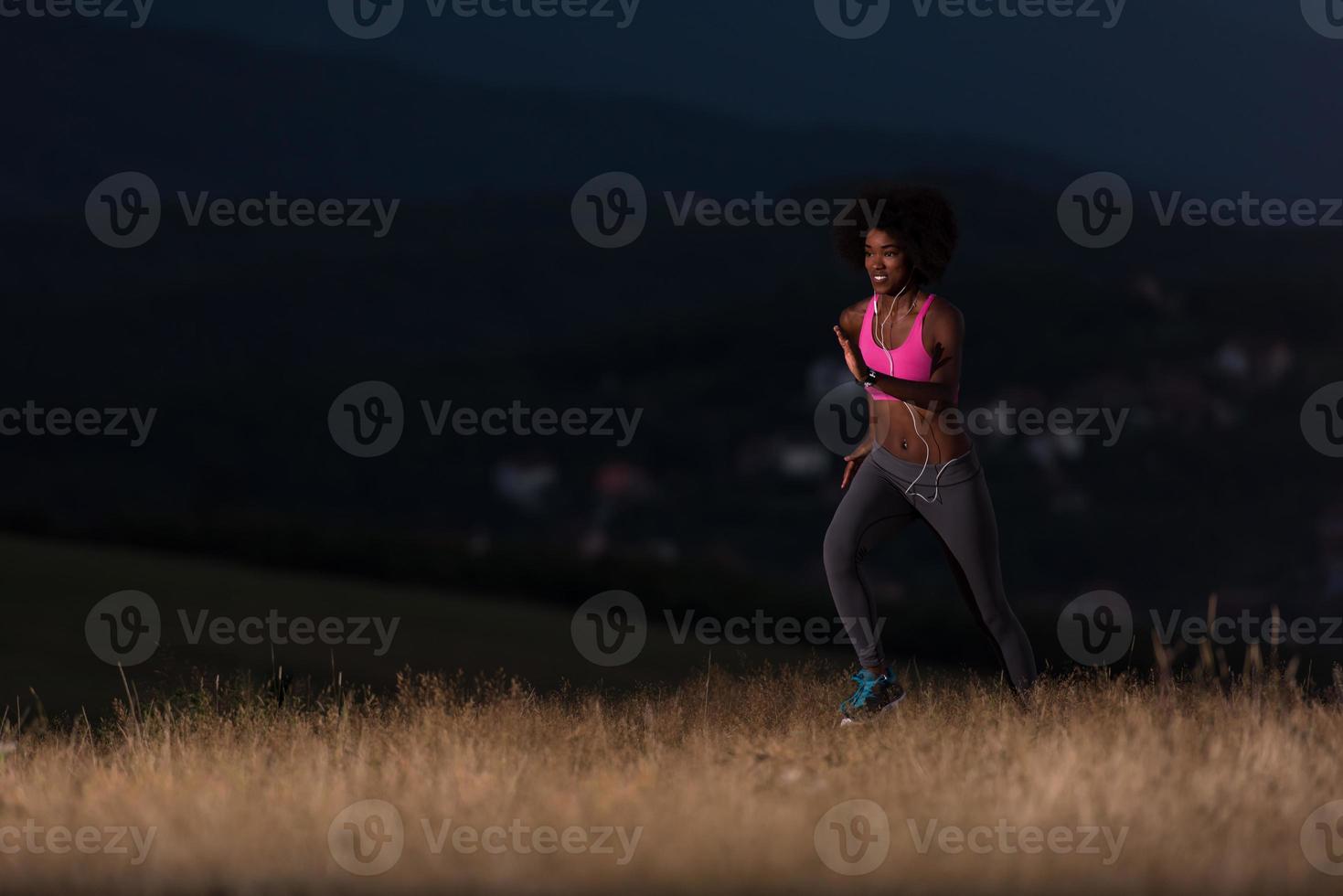 Young African american woman jogging in nature photo